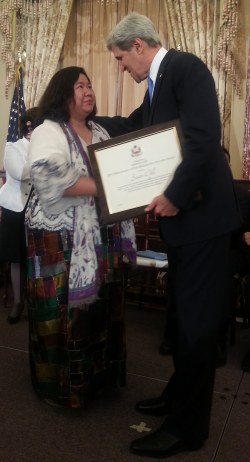 Secretary of State John Kerry thanks Susan Ople for helping trafficked victims as he hands her the 2013 Hero Acting to End Modern-Day Slavery Award