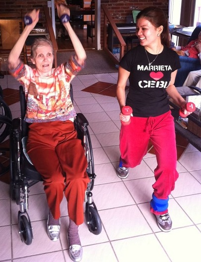 Marrieta Itom Barcelon does weights with one of her residents.