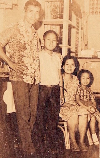 Gene, as a young student of Don Bosco, with his father Benigno, his mother Victoria, and younger sister Cristina in a family snapshot.