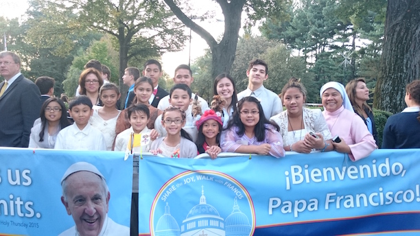 The group of 13 Filipino-American children with Sr. Glecy Cruz and Vice Consul Darell Artates await Pope Francis outside the Vatican Embassy in Washington, DC.