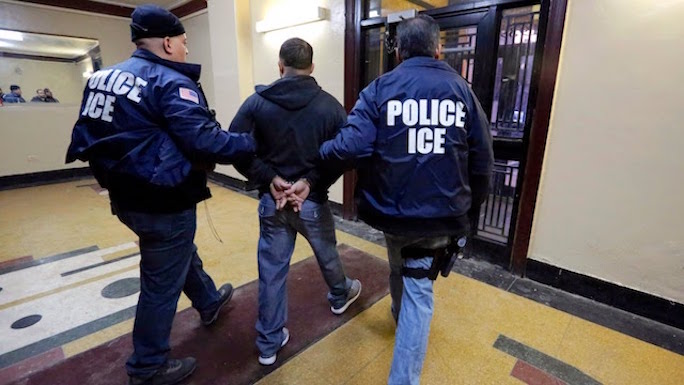 U.S. Immigration and Customs Enforcement (ICE) taking an undocumented immigrant into custody.  