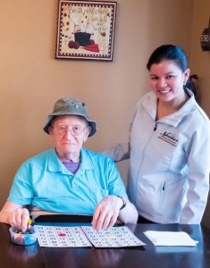 Marrieta and a resident enjoying game of Bingo 