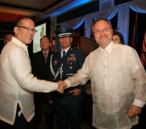 President Benigno S. Aquino (left) congratulates FASO Conductor Robert Shroder after a musical performance in his honor in 2012.