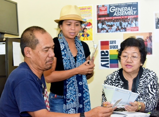 Dondi Mangan, service recipient, learns about the Changes Program  from staff Teresita Mercado.  PWC Executive Director Aqui Versoza (standing) guides the briefing. Photo by Tet Valdez.