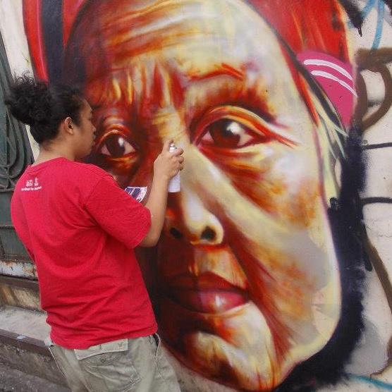 Sim Tolentino puts finishing touches to a mural