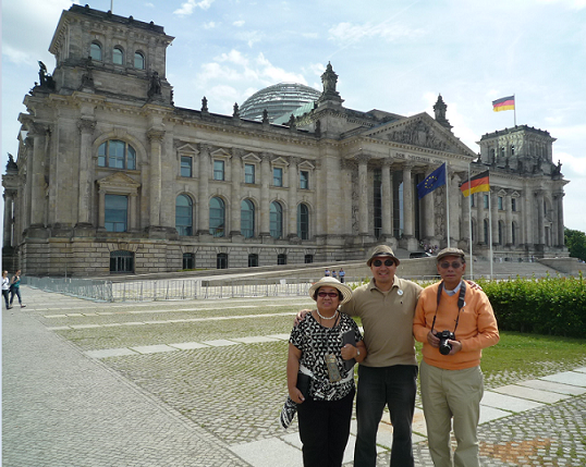 Top, the author with his parents, Ambassador Willy C. Gaa and Linda Gaa, in front of the Reichstag building, home to the German parliament ("Bundestag"), and with the huge glass dome on its roof. Below, Amb. Willy and Linda Gaa touring the East Side Gallery of the Berlin Wall.