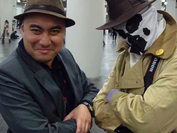 The author pictured with a cosplayer dressed up as Rorschach, one of the main characters of the DC Comics series ‘Watchmen.’