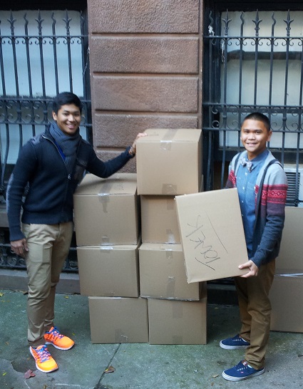 Students Patrick Dy (left) and Nino Villamor proud of the ‘balikbayan’ boxes filled with donations from school community