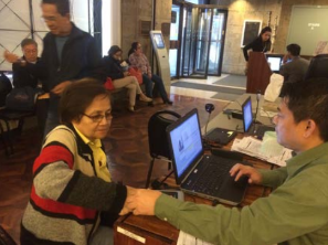 Consular staff assists Amelia Lasig, the first senior citizen OV registrant