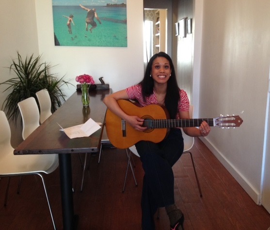 Brenda loves to sing and play the guitar. Here she is in the  dining area.