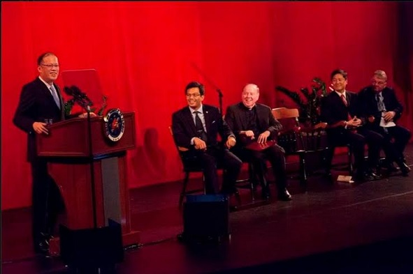 President Aquino speaks to the Boston College community, waxing nostalgic about his first bitterly cold Christmas 31 years ago. The Aquino family lived in the Boston area for several years during the 1980s. In the panel are (from left) Matthew Alonsozana, Boston College President Fr. William Leahy, Professor Min Song, and Associate Vice Provost J.J. Burns. Photo by Caitlin Cunningham, Boston College 