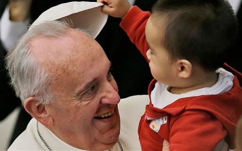 Hugging babies: One of the endearing moments during the papal visit. Photo: CBCP