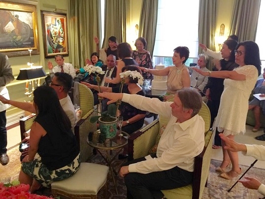Guests raise their hands signifying their blessings for the couple  and their union