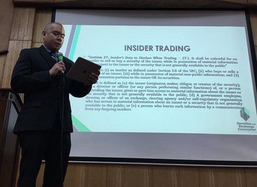 Giving a presentation: His work involves drafting legal decisions on issues such as insider trading 
