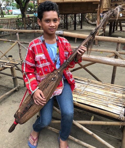 Davaoeno teen with his traditional lute. 